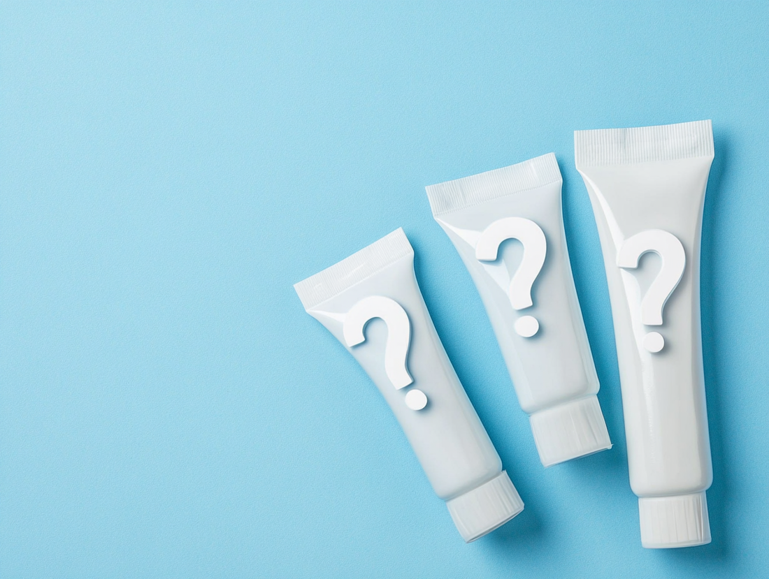 Three toothpaste tubes with question marks on a blue background