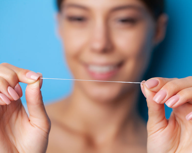 Woman showing a string of a floss
